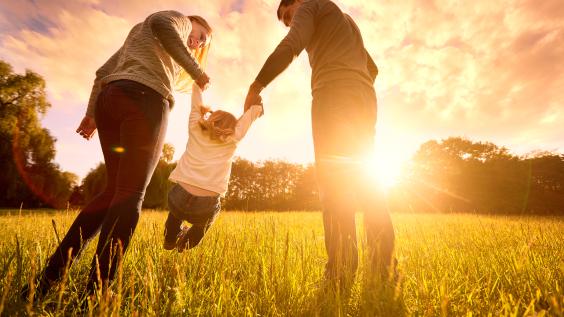Parents hold the baby's hands