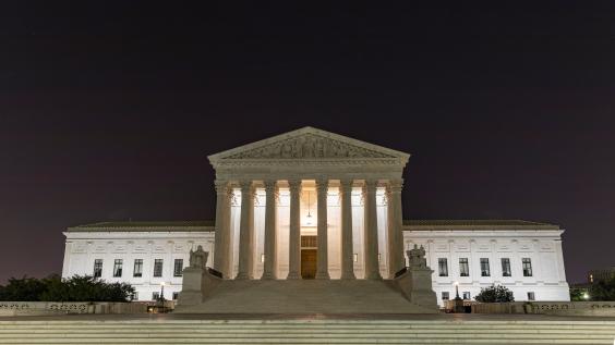U.S. Supreme Cout Building at night under the crescent moon, Washington D.C.