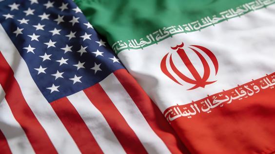 Close up view of the draped national flags representing the United States and Iran illustrating diplomatic relations issues.
