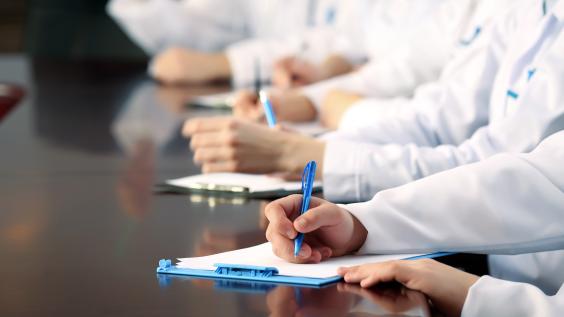 Medical workers working in conference room.