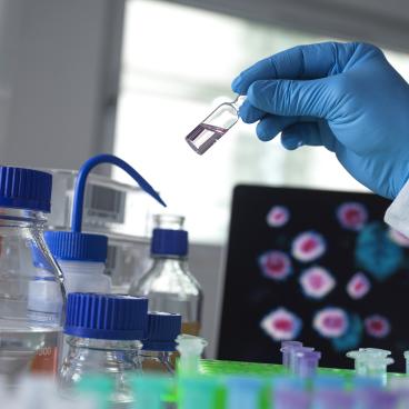 Scientist holding a vial