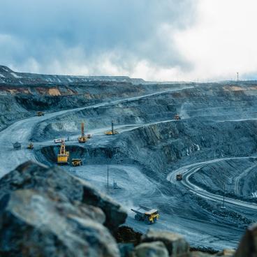 Trucks and the excavator in an open pit 