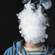 Person blowing out vape smoke