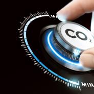 A person's hand on dial with carbon dioxide (CO2) written on it.