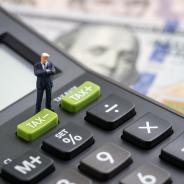 Calculator atop dollar bills