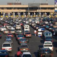 Multiple rows of cars lined up at the US-Mexico border. 