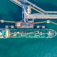 An oil tanker docks at a port.