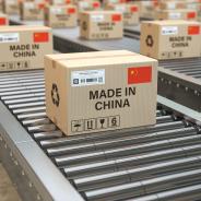 Boxes labeled "MADE IN CHINA" move along a production line.