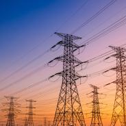 Transmission towers against a sunset.
