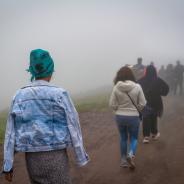 Refugees walk on dirt path