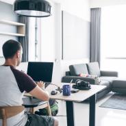 A person doing remote work on their laptop from their house.