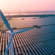 Wind turbine over solar farm