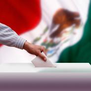 Ballot box in front of the Mexican flag