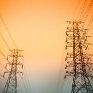 Transmission towers against a sunset.