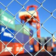 Trade containers behind a fence.