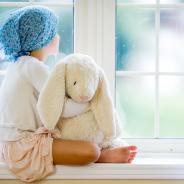 Child staring out of a window