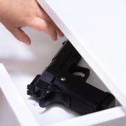 Child opening drawer containing gun