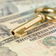 A key lies on top of money.