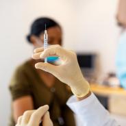 A nurse administers a COVID-19 vaccination.