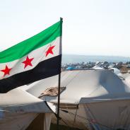 The Syrian revolution flag waves over refugee camps.