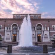 The front of Baker Hall, from across the plaza, with fountain in foreground