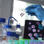 Scientist holding a vial
