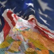 US flag drapes around Middle East regional map