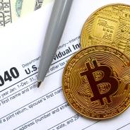 Bitcoins lie on an income tax form.
