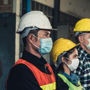 Construction workers wear masks.