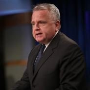 Ambassador John J. Sullivan speaking at podium