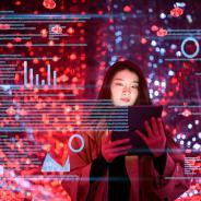 Young woman uses digital tablet on virtual visual screen at night