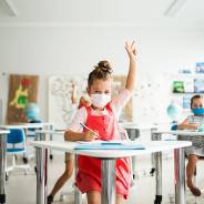 Young students wear COVID masks in the classroom