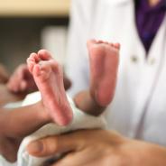 Newborn baby and doctor