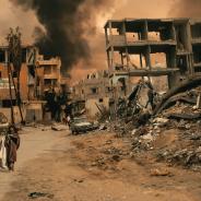 Walking in destroyed city, a little girl seeks shelter