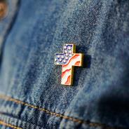 Christian cross pin on denim background
