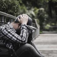 Anxious man with head in hands