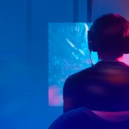 Gamer playing game on large screen monitor
