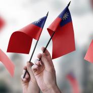  A group of people holding small flags of the Taiwan in their hands
