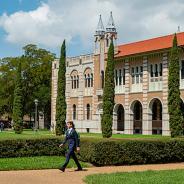 A students walks through Rice University campus