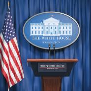 Podium speaker tribune with US flags and sign of White House