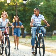  Friends riding bicycles and walking in the park