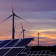 Solar panels in front of wind turbines