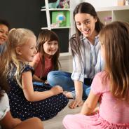 Children with nursery teacher in kindergarten