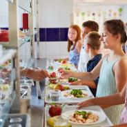  Elementary students at buffet line, enjoying variety of food options