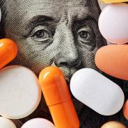 Capitalism and healthcare policy concept. Colorful medical pills cover Benjamin Franklin's face on one hundred American dollar bill. Macro top down view.