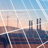 Natural gas processing plant with renewable energy wind turbines generating electricity reflection to solar panels at sunset