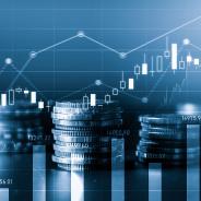 stacks of coins with graphs floating behind