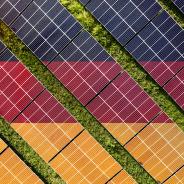 Solar farm superimposed with flag of Germany. Symbolizing solar power and panel demand, renewable energy industry, government policy, and sustainability initiatives in the country.