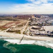 A drone shot look at the San Diego-Tijuana border from the pacific direction.