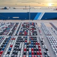 Aerial view vehicle carrier vessel loading car for shipping to worldwide, Large RoRo (Roll on/off) vehicle car carrier, New car lined up in the port for import export around the world.